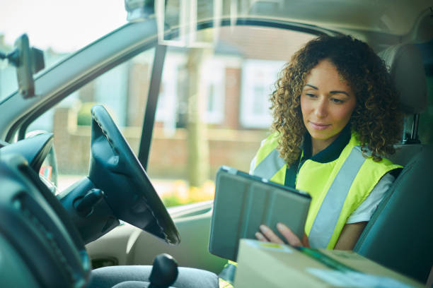 Delivery driver in a van with a handheld device