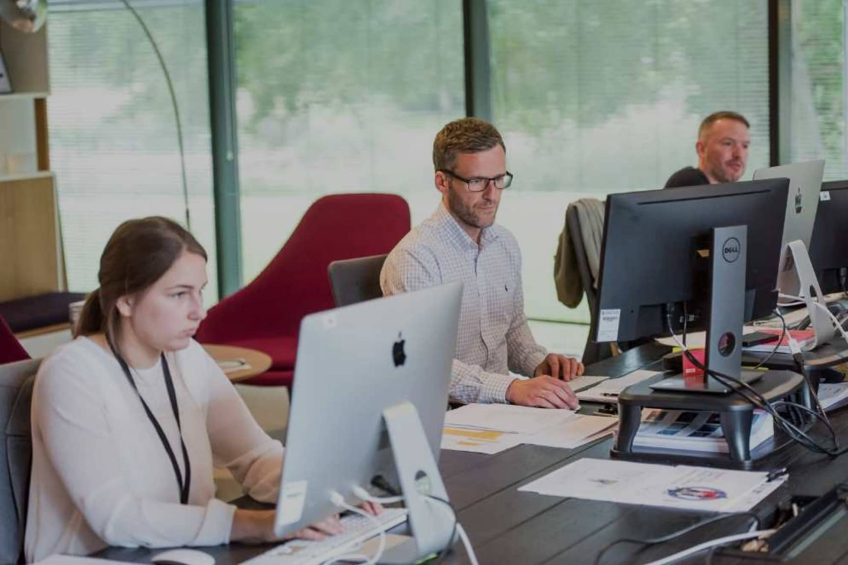 People working on a shared desk space