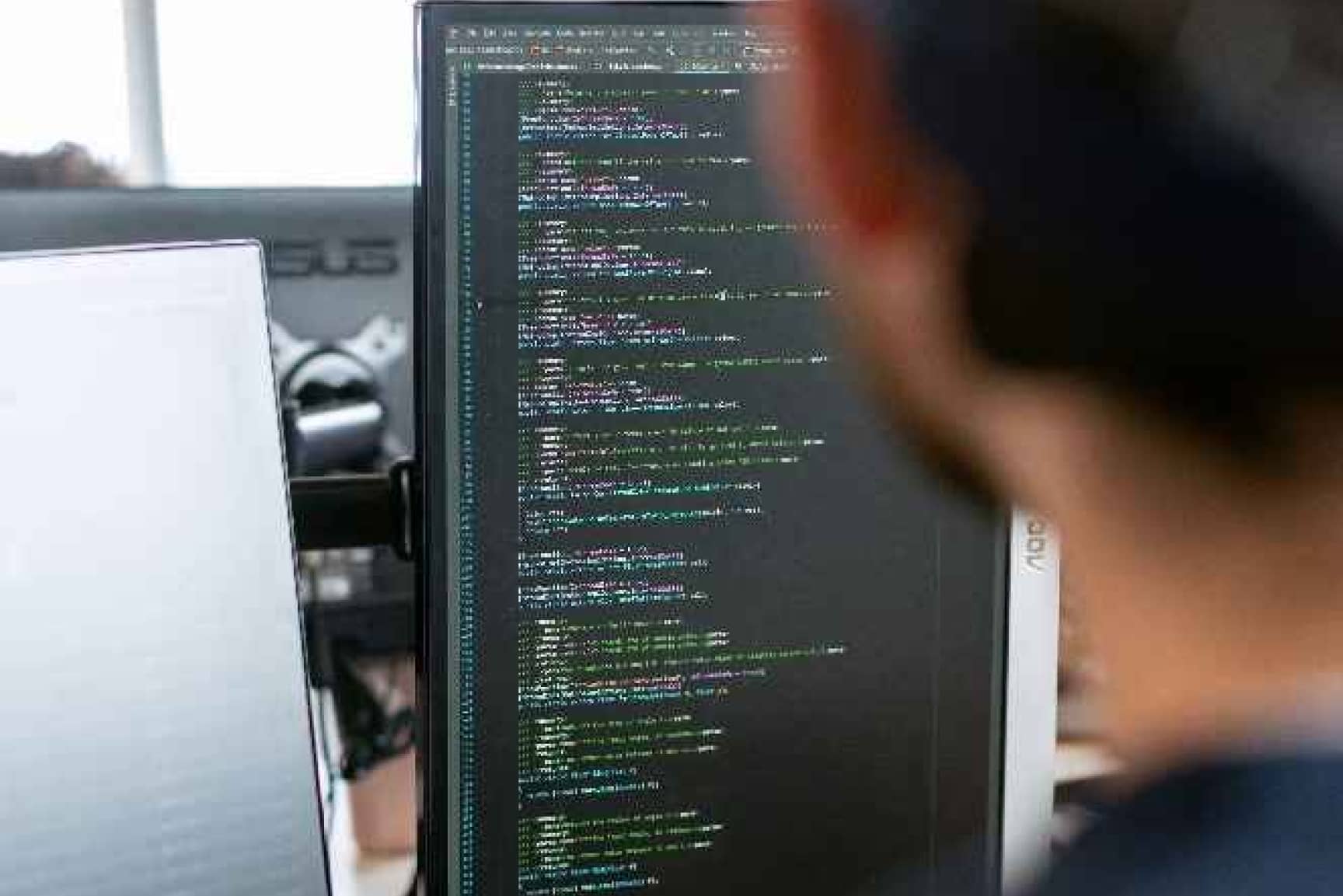 Man looking at computer code