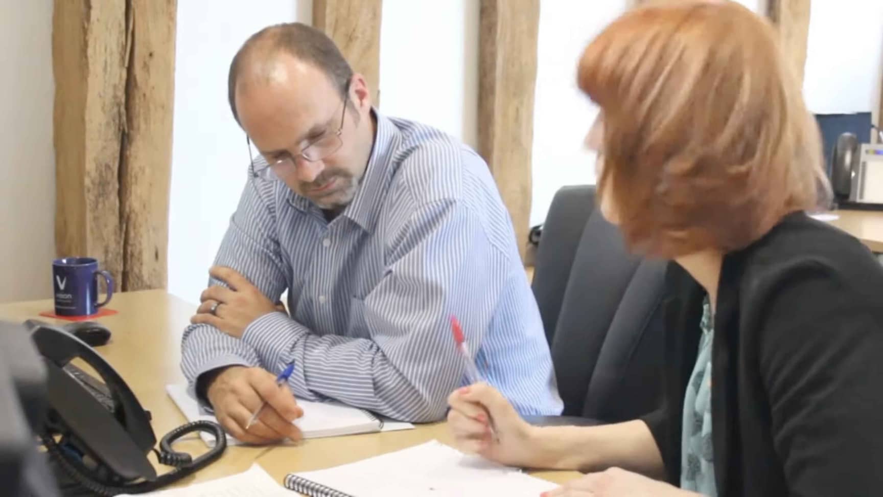 Two colleagues discussing work