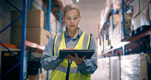 Women in warehouse chekcing stock