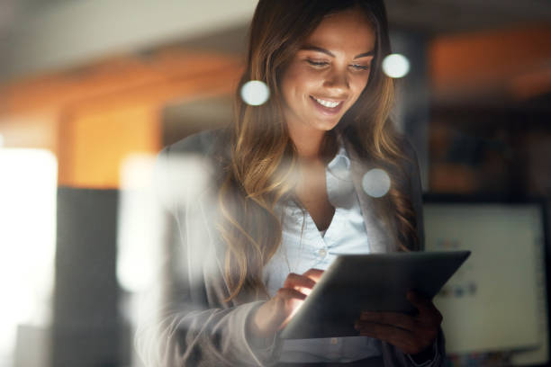 Women smiling using a tablet